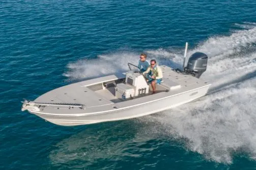 Slide: The Image of Manufacturer Provided Image: 2026 Hewes Redfisher 21 boat speeding on open water, two people onboard. - 47