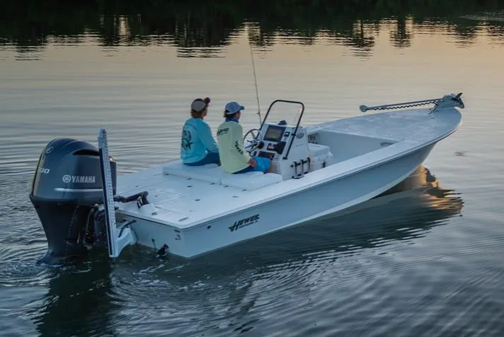Slide: The Image of Manufacturer Provided Image: 2026 Hewes Redfisher 21 boat on calm water at sunset, two people onboard. - 48