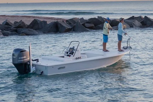 Slide: The Image of Manufacturer Provided Image: 2026 Hewes Redfisher 21 boat with two people fishing near rocky shoreline. - 50