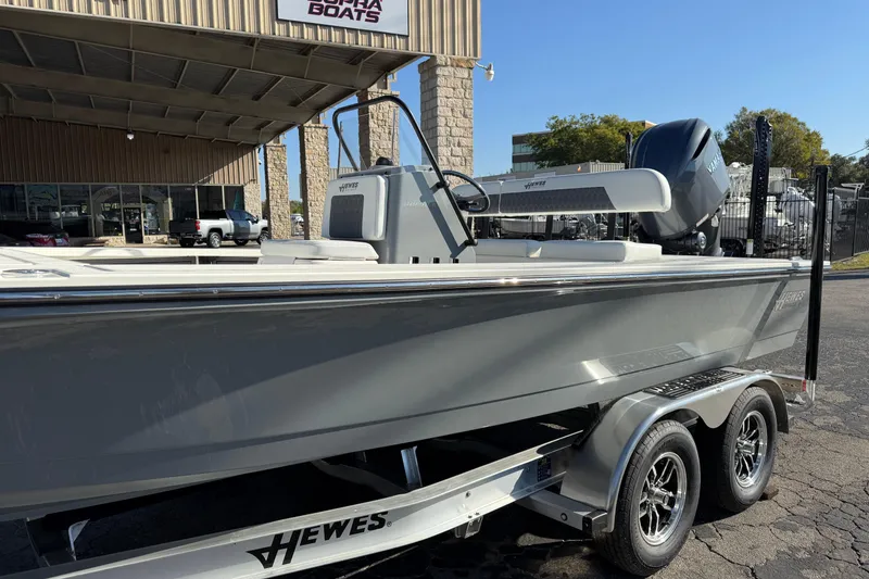 Slide: The Image of 2026 Hewes Redfisher 21 boat on trailer at dealership, showcasing sleek design. - 6