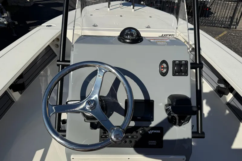 Slide: The Image of 2026 Hewes Redfisher 21 boat console with steering wheel and navigation controls. - 9