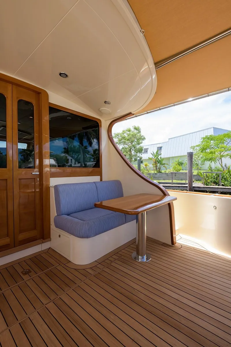 Slide: The Image of 2018 Palm Beach Motor Yachts PB55 interior with control panel, overlooking serene waterfront. - 14