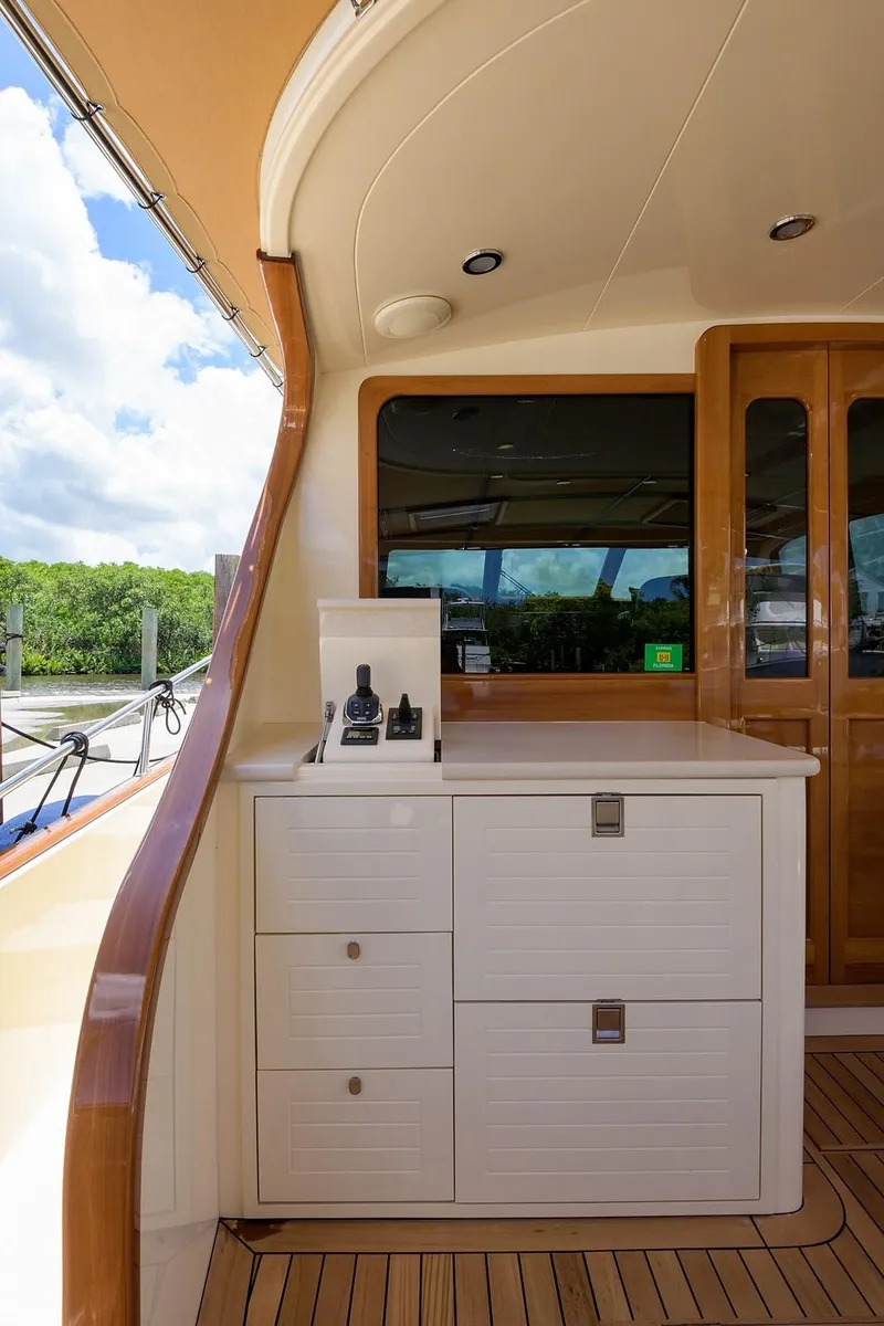 Slide: The Image of Luxurious 2018 Palm Beach Motor Yachts PB55 interior with elegant wood finish and waterfront view. - 17