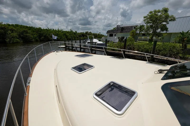 Slide: The Image of Luxurious interior of 2018 Palm Beach Motor Yachts PB55 with wooden cabinetry and scenic windows. - 20
