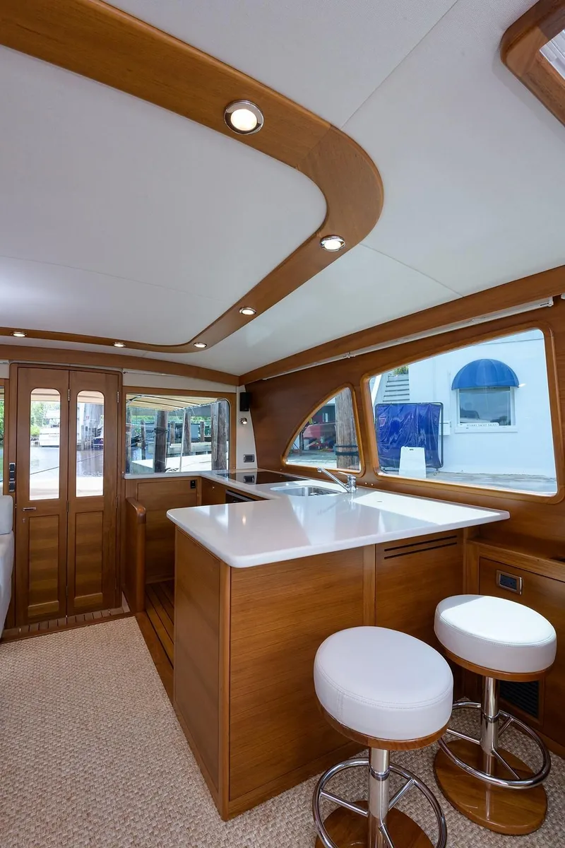 Slide: The Image of Luxurious cabin interior of 2018 Palm Beach Motor Yachts PB55 with elegant bedding and wood finishes. - 33