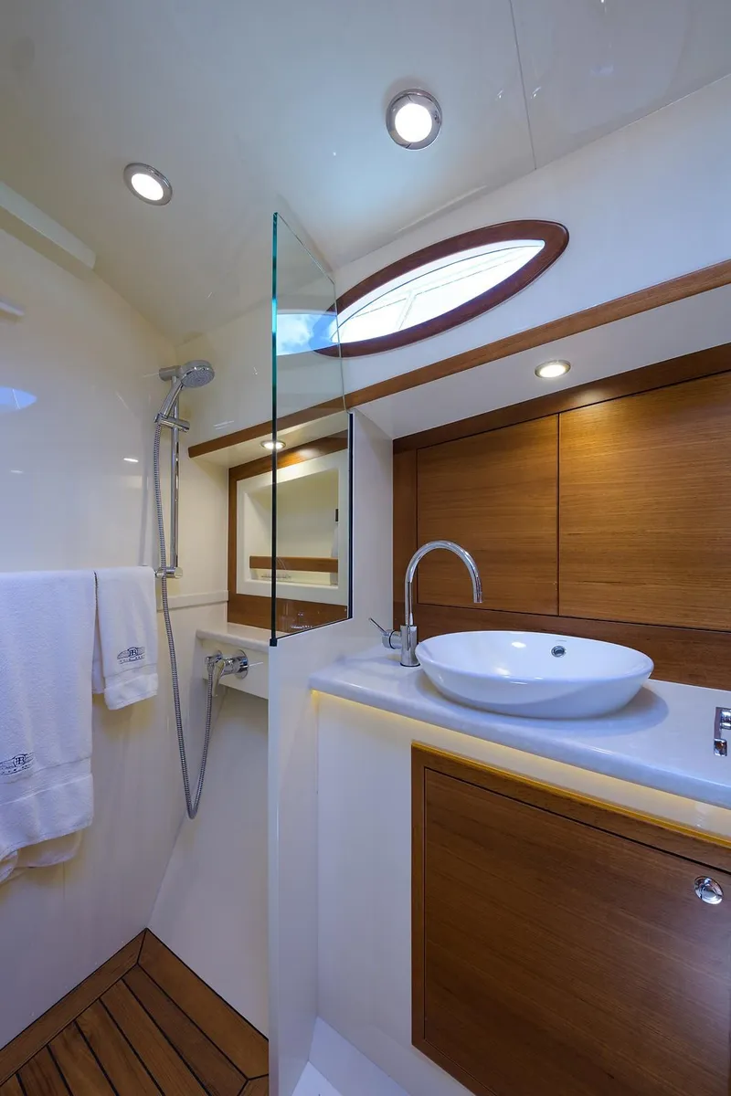 Slide: The Image of 2018 Palm Beach Motor Yachts PB55 cruising on open water, showcasing sleek design and performance. - 54