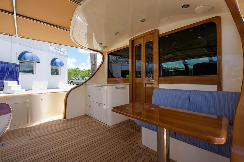 Slide: The Image of 2018 Palm Beach Motor Yachts PB55 cruising near waterfront homes under clear blue skies. - 15