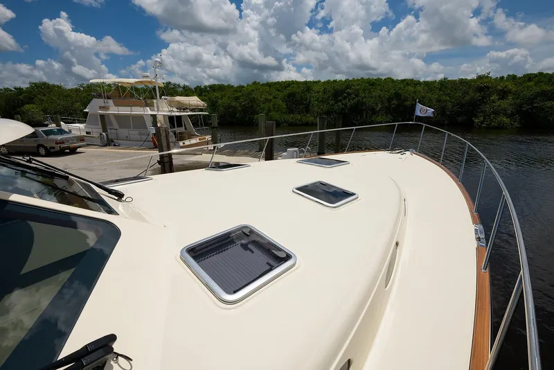 Slide: The Image of Luxurious interior of 2018 Palm Beach Motor Yachts PB55 with elegant wood finish and waterfront view. - 23