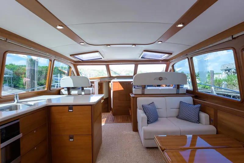 Slide: The Image of 2018 Palm Beach Motor Yachts PB55 helm with navigation display and luxurious interior. - 24