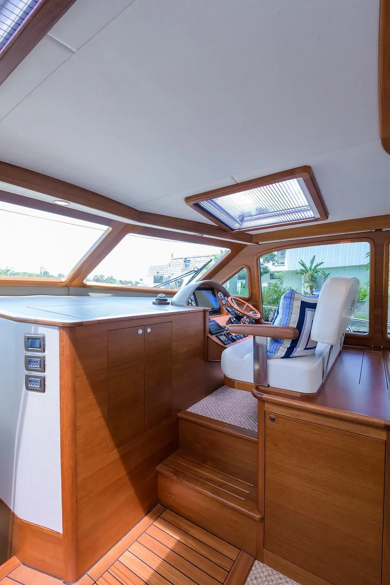 Slide: The Image of Luxurious 2018 Palm Beach Motor Yachts PB55 interior with elegant wood finish and waterfront view. - 3