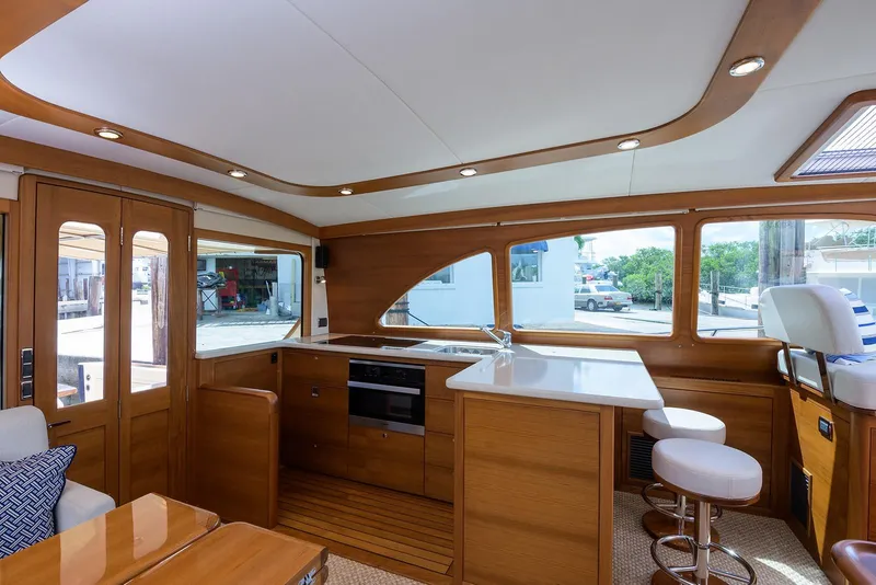Slide: The Image of Luxurious wooden interior of 2018 Palm Beach Motor Yachts PB55, featuring elegant cabinetry and lighting. - 32
