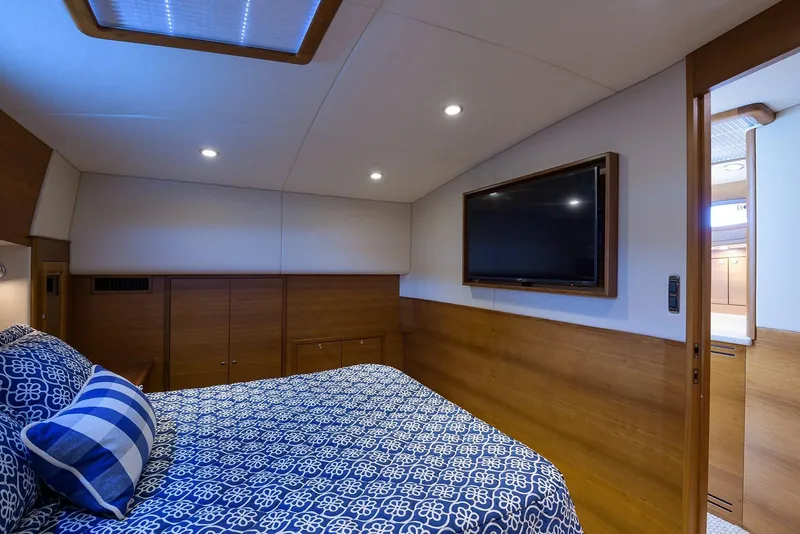 Slide: The Image of Luxurious 2018 Palm Beach Motor Yachts PB55 cabin interior with wood accents and striped bedding. - 43