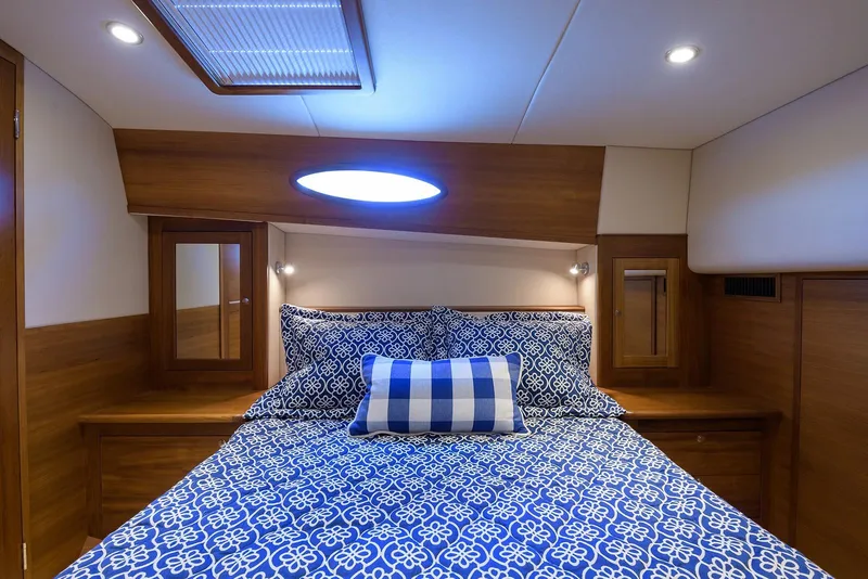 Slide: The Image of Luxurious bathroom in 2018 Palm Beach Motor Yachts PB55, featuring elegant wood cabinetry and modern fixtures. - 44