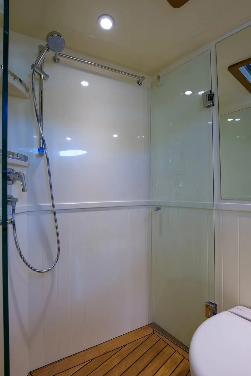 Slide: The Image of Engine room of 2018 Palm Beach Motor Yachts PB55 with wooden flooring and mechanical components. - 48