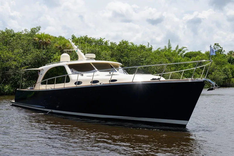 Slide: The Image of Luxurious cabin interior of 2018 Palm Beach Motor Yachts PB55 with elegant bedding and wood finish. - 5