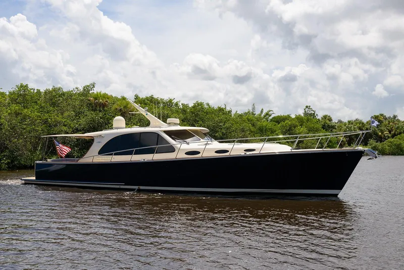 Slide: The Image of 2018 Palm Beach Motor Yachts PB55 cruising on open water, showcasing sleek design. - 7