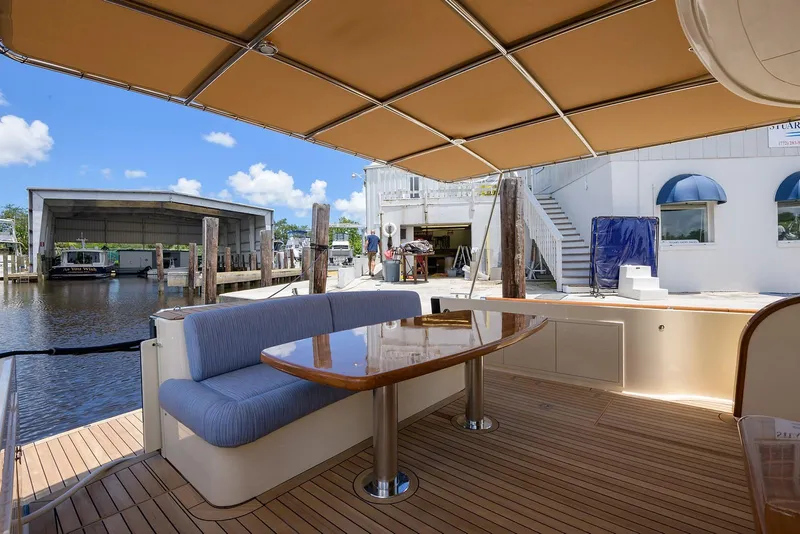 Slide: The Image of 2018 Palm Beach Motor Yachts PB55 cruising on serene waters, surrounded by lush greenery. - 8