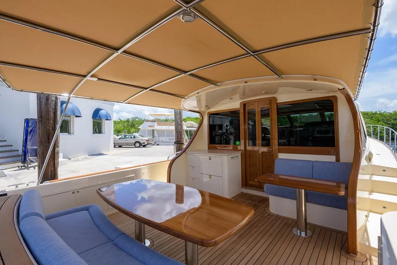 Slide: The Image of 2018 Palm Beach Motor Yachts PB55 cruising on calm waters, featuring elegant design and spacious deck. - 9