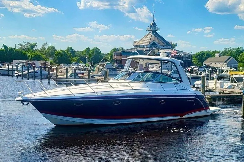 The Image of 2006 Formula 40 Performance Cruiser docked at a marina under a clear blue sky. - 1