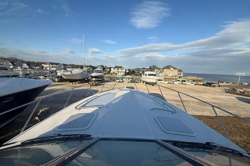 Slide: The Image of 2006 Formula 40 Performance Cruiser docked at a marina with scenic waterfront view. - 10