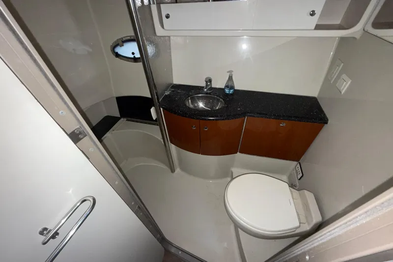 Slide: The Image of 2006 Formula 40 Performance Cruiser bathroom with sink, toilet, and storage cabinets. - 11
