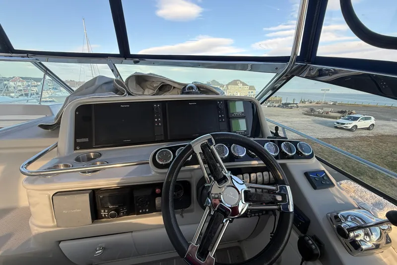 Slide: The Image of Helm of 2006 Formula 40 Performance Cruiser with modern navigation instruments and steering wheel. - 27