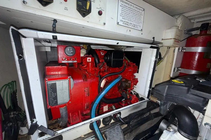 Slide: The Image of Engine compartment of a 2006 Formula 40 Performance Cruiser with red machinery and control panel. - 33