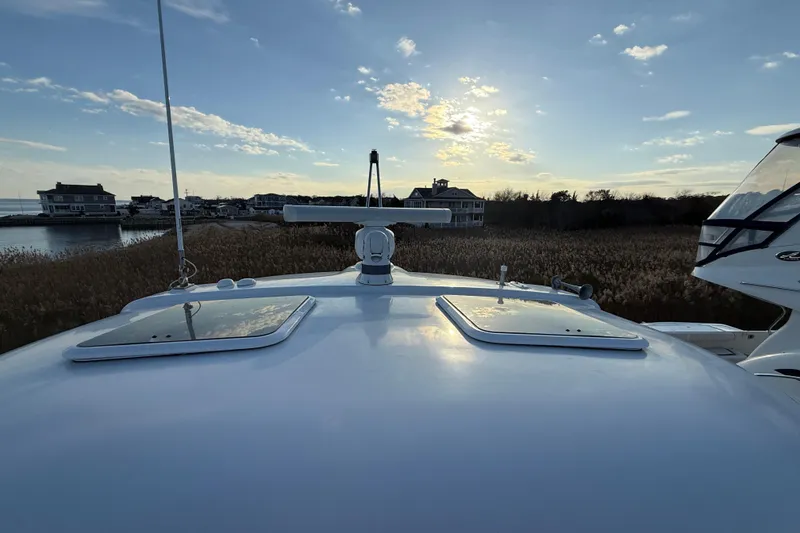 Slide: The Image of 2006 Formula 40 Performance Cruiser on water at sunset, with scenic background. - 4