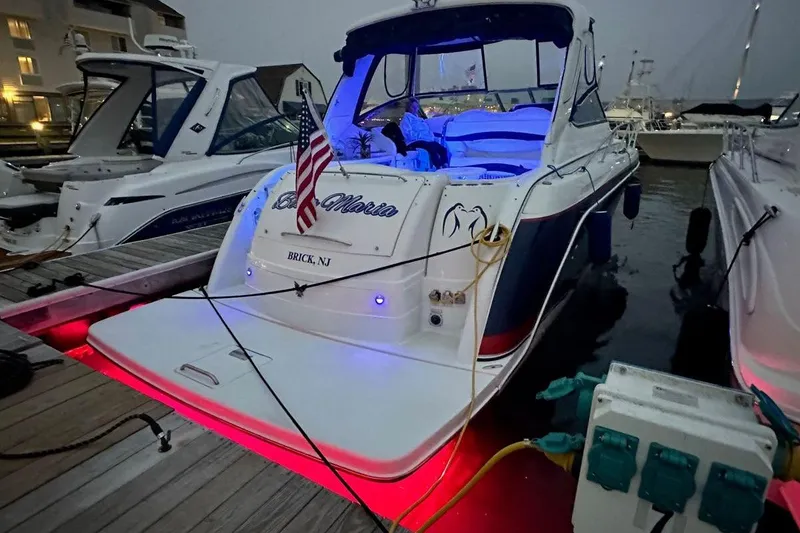 Slide: The Image of 2006 Formula 40 Performance Cruiser docked with illuminated deck and American flag. - 43