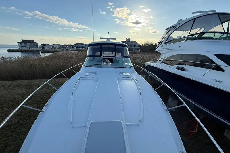 Slide: The Image of 2006 Formula 40 Performance Cruiser docked near waterfront homes at sunset. - 5