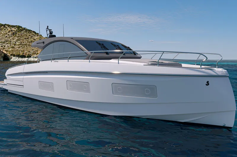 Slide: The Image of 2026 Beneteau Gran Turismo 50 yacht on serene blue waters near rocky coastline. - 2