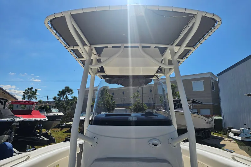Slide: The Image of 2015 Wellcraft 252 Fisherman boat with T-top under sunny sky. - 11