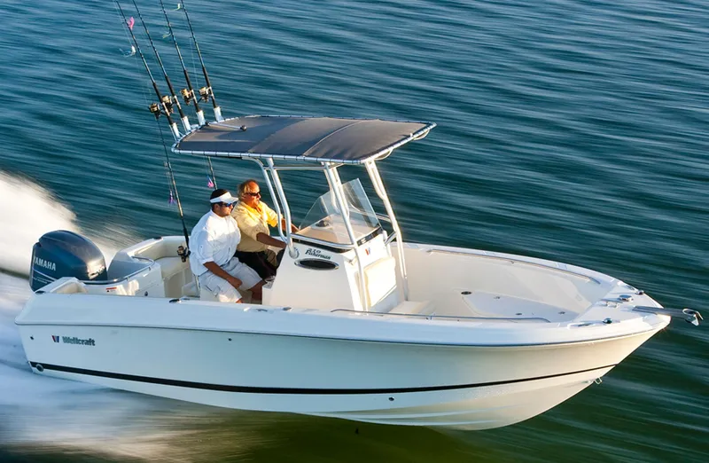 Slide: The Image of Manufacturer Provided Image: 2015 Wellcraft 252 Fisherman boat cruising on water with two passengers. - 15