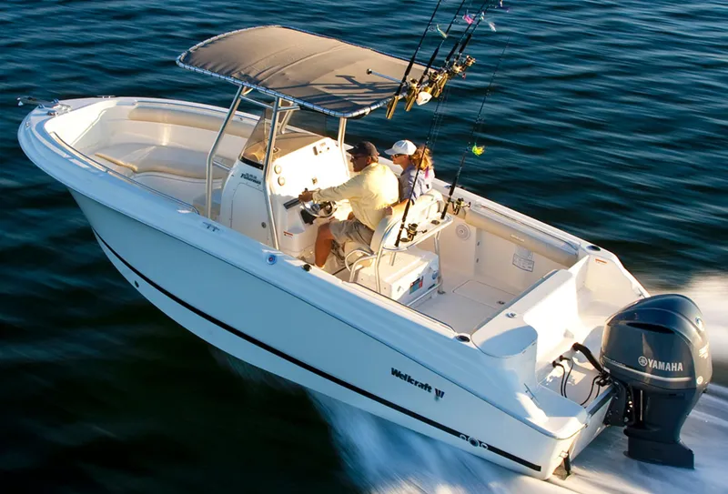 Slide: The Image of Manufacturer Provided Image: 2015 Wellcraft 252 Fisherman boat cruising on water with fishing rods. - 17