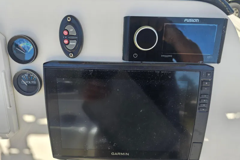 Slide: The Image of Interior of 2015 Wellcraft 252 Fisherman boat showing storage and electrical components. - 24