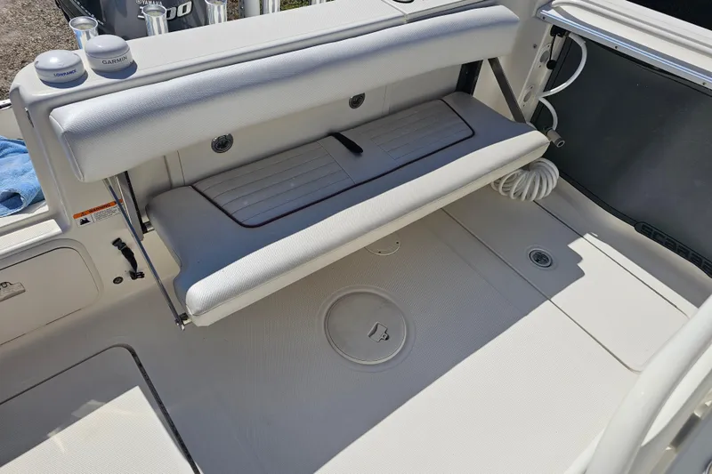 Slide: The Image of 2015 Wellcraft 252 Fisherman boat interior with cushioned seating and stainless steel fixtures. - 29