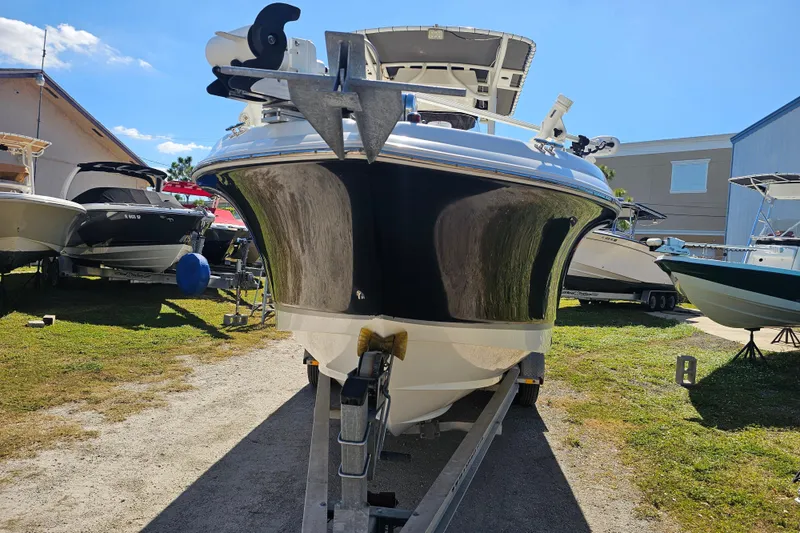 Slide: The Image of 2015 Wellcraft 252 Fisherman boat with Yamaha engine, parked on trailer, palm trees in background. - 4