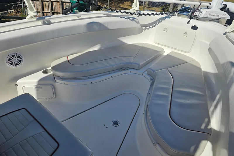 Slide: The Image of 2015 Wellcraft 252 Fisherman boat interior with cushioned seating and storage compartments. - 7