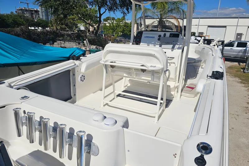 Slide: The Image of 2015 Wellcraft 252 Fisherman boat interior with fishing rod holders and seating. - 8