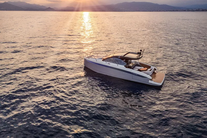 Slide: The Image of 2026 Beneteau Gran Turismo 40 yacht cruising at sunset on calm waters. - 21