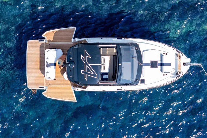 Slide: The Image of Aerial view of 2026 Beneteau Gran Turismo 40 yacht on clear blue water. - 4