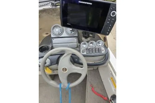 Slide: The Image of 2004 Crestliner 1750 Fish Hawk SC dashboard with steering wheel and navigation system. - 3