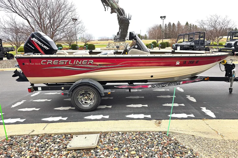 Slide: The Image of 2004 Crestliner 1750 Fish Hawk SC boat on trailer, parked outdoors. - 8