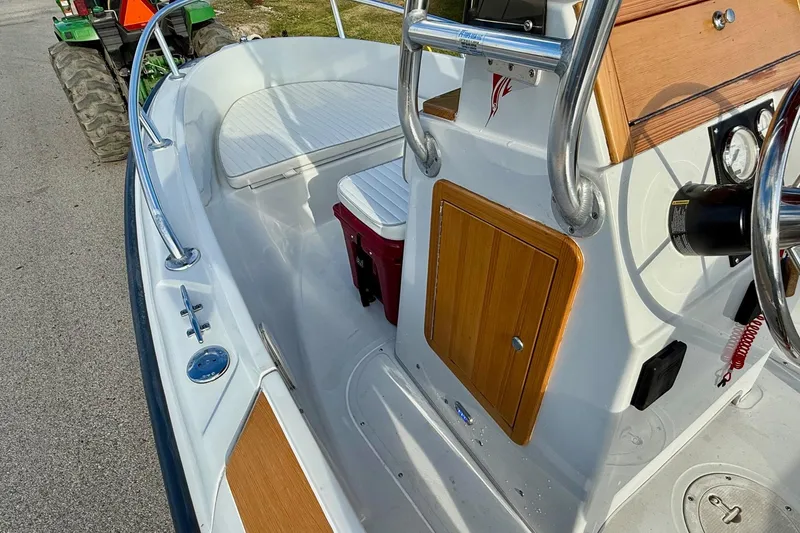 Slide: The Image of 1997 Boston Whaler 17 Outrage II boat interior with wood accents and steering console. - 11