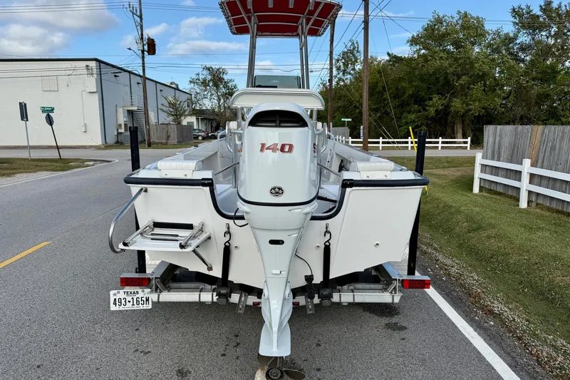 Slide: The Image of 1997 Boston Whaler 17 Outrage II with Suzuki 140 outboard on trailer, street view. - 2