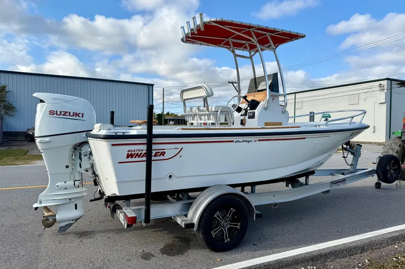 Slide: The Image of 1997 Boston Whaler 17 Outrage II boat on trailer with Suzuki outboard motor. - 3