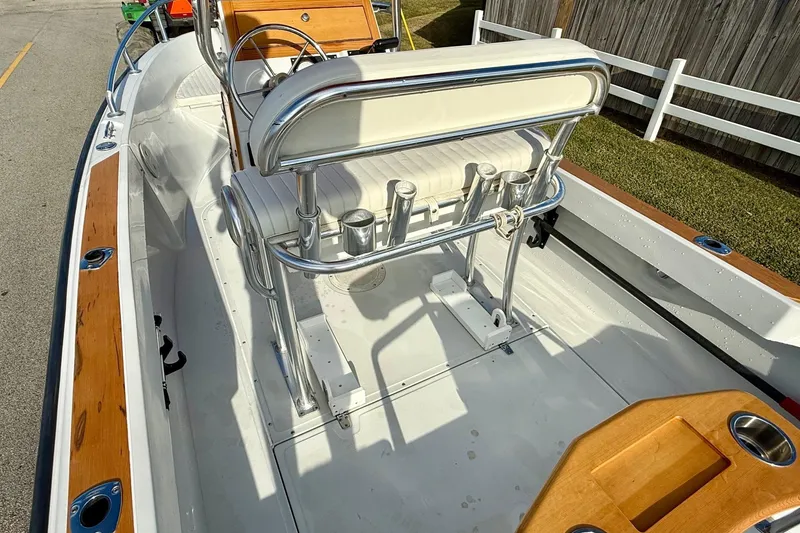 Slide: The Image of 1997 Boston Whaler 17 Outrage II boat interior with seating and rod holders. - 7