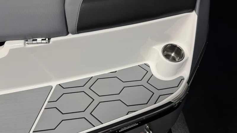 Slide: The Image of MasterCraft NXT24 2026 interior with gray upholstery and cup holder. - 12