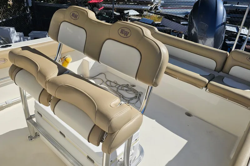 Slide: The Image of 2017 Key West 239 FS boat interior with beige seating and storage. - 15