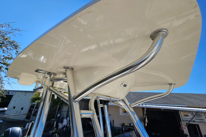 Slide: The Image of 2017 Key West 239 FS boat with stainless steel T-top structure under clear blue sky. - 17